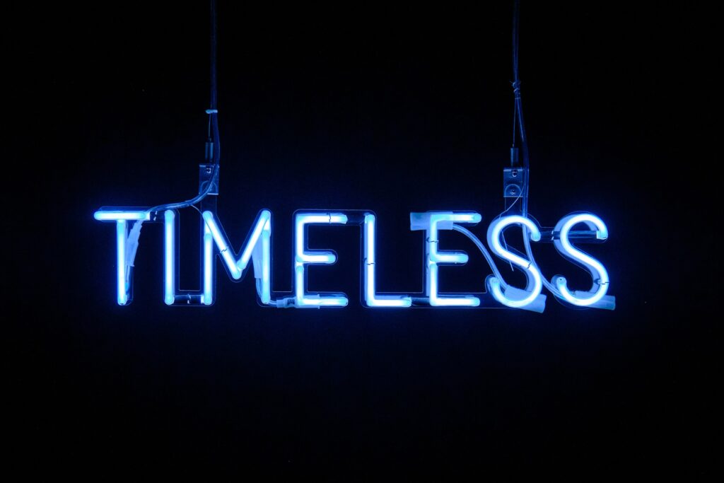 timeless word in a neon light in the dark background