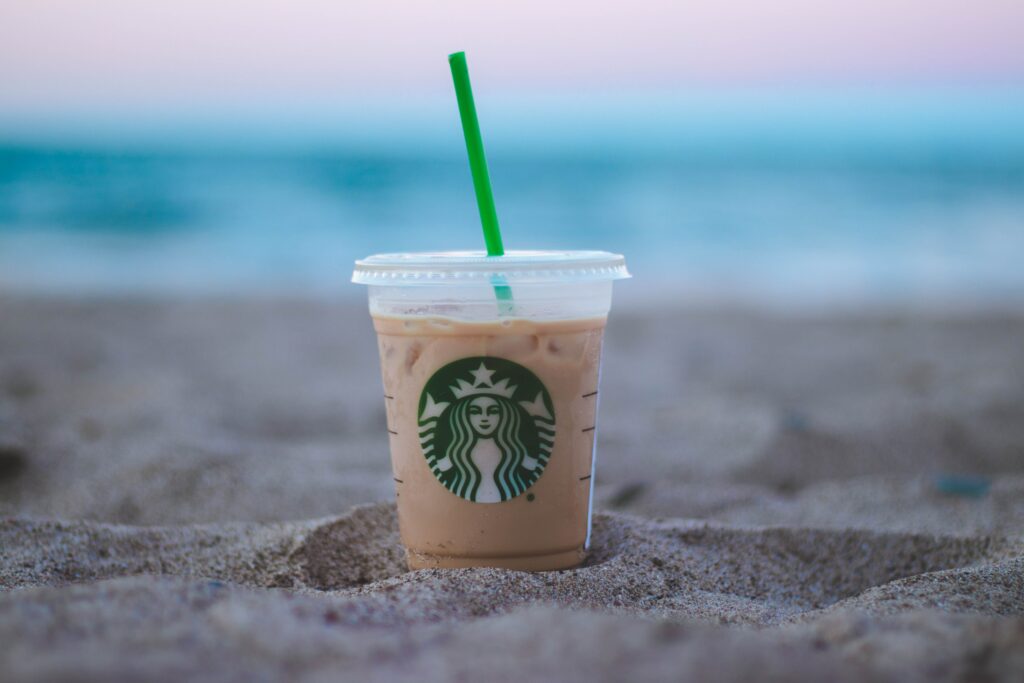 starbucks drink in sand at the beach