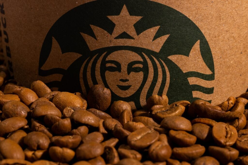 starbucks emblem siren with coffee beans in front