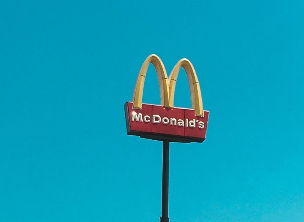 MCDOnalds stand outside with the sky as the background