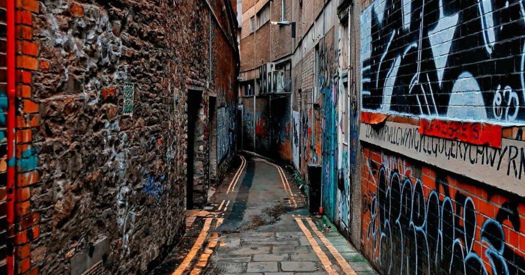 Narrow Street with Street Art Designs in the Walls In Between