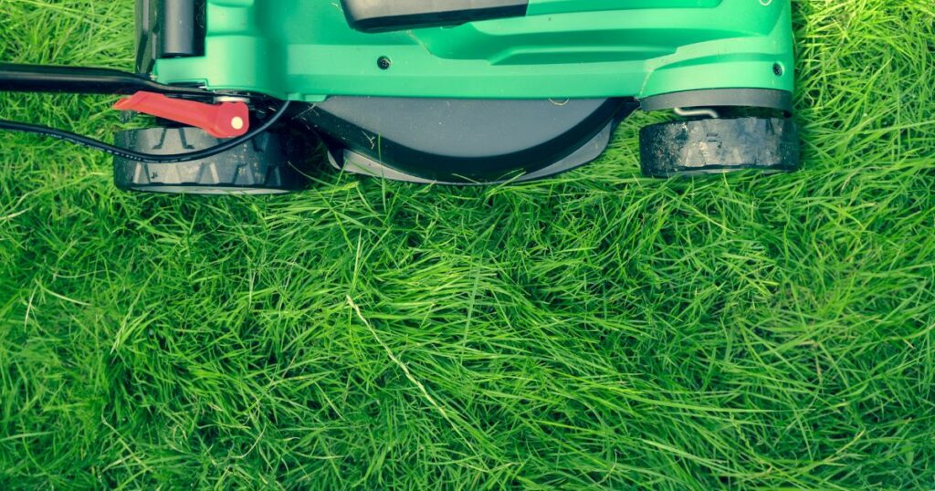 aerial shot of lawn mower in grass