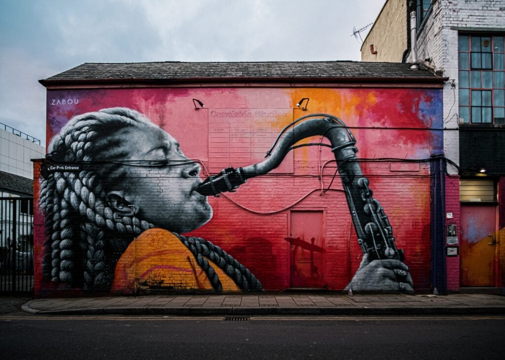 photo taken in one of the beautiful street art in US with a girl playing a trumpets