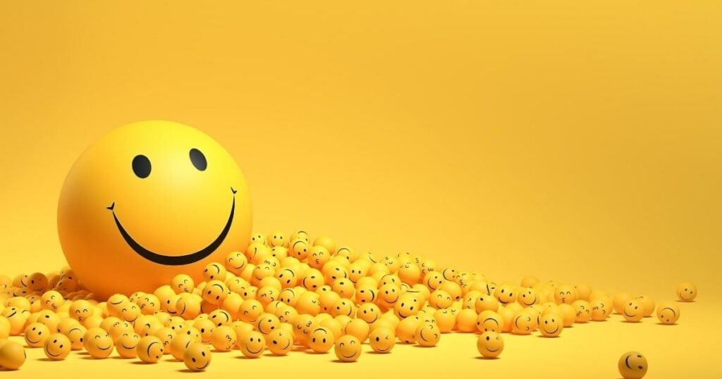 big smile emoji with small smile emoji around and a yellow background