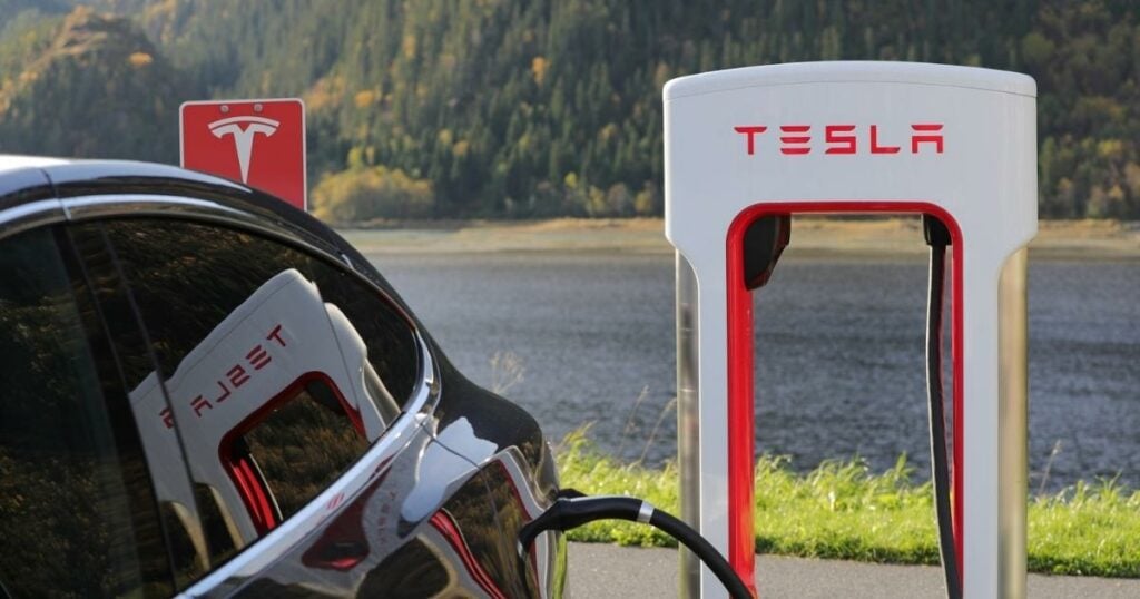 charging station for the tesla vehicle / car with an actual car charging