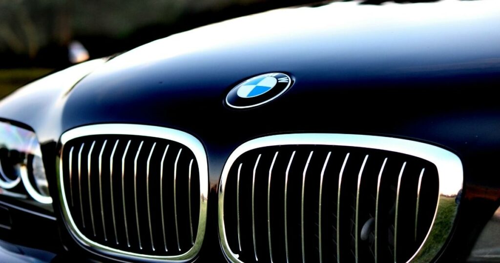 shot of a front view of the bmw car focusing on the front panel and the bmw logo