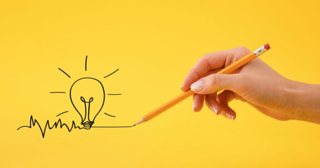 a photo of light bulb as seems like drawn by a pencil with a yellow-orange background