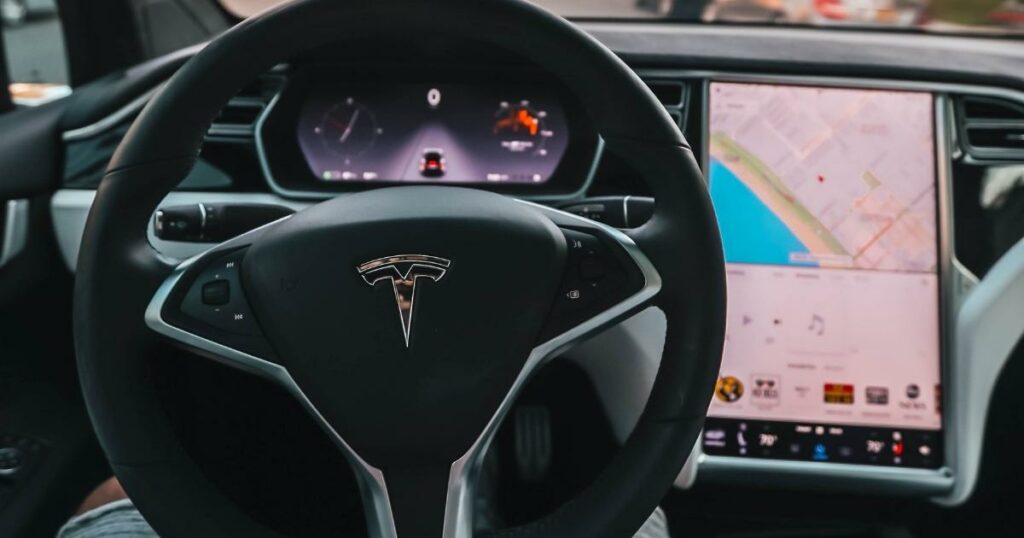 shot that shown the tesla icon or logo design attached on the steering wheel