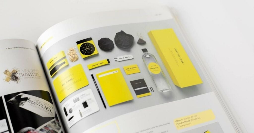 an opened page of a magazine that shows a the visual image or identity of a brand that uses mainly the colors yellow and black.