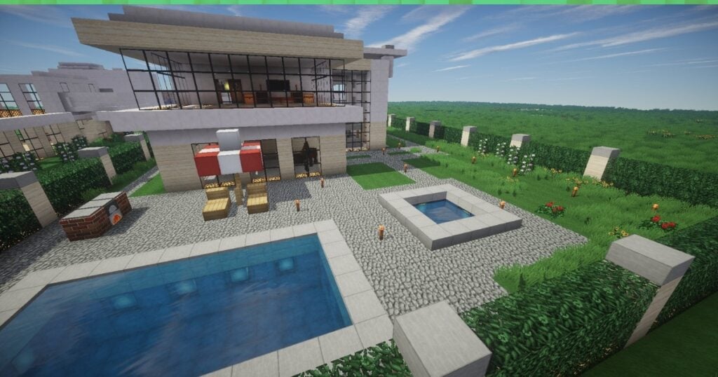 Screenshot capturing a grand Minecraft mansion featuring a pool, grassy surroundings, and fences.