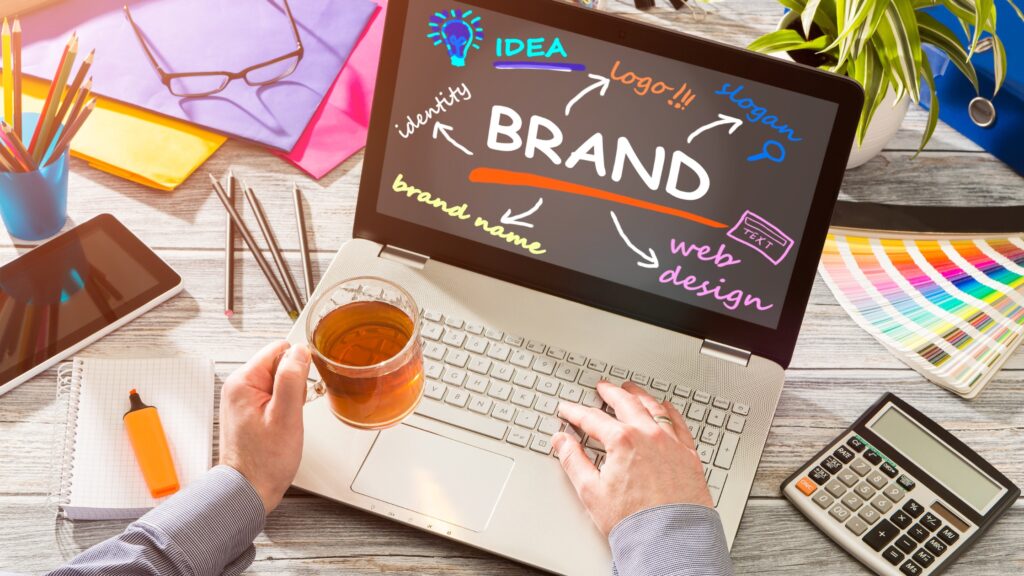 the word brand as written on the laptop screen with other ideas making up a successful brand